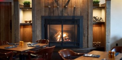 Wayfarer Restaurant and Lounge dining tables and fireplace
